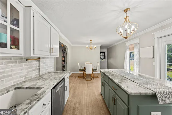 a spacious bathroom with a granite countertop sink a large mirror and a refrigerator