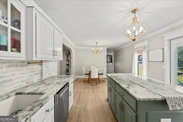 a spacious bathroom with a granite countertop sink a large mirror and a refrigerator
