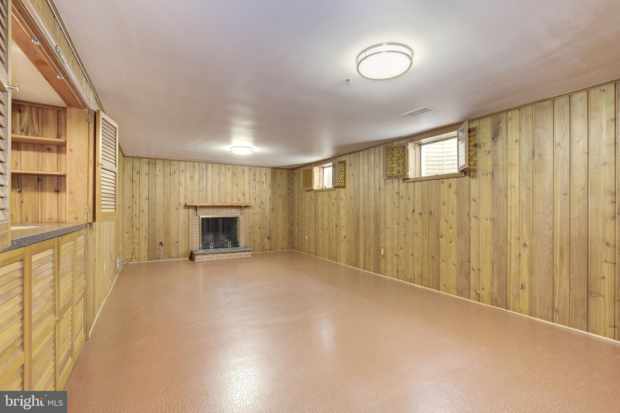 4709 River Road Bethesda, MD 20816 - Photo 37 of 52 Family/Recreation room with wood burning fireplace