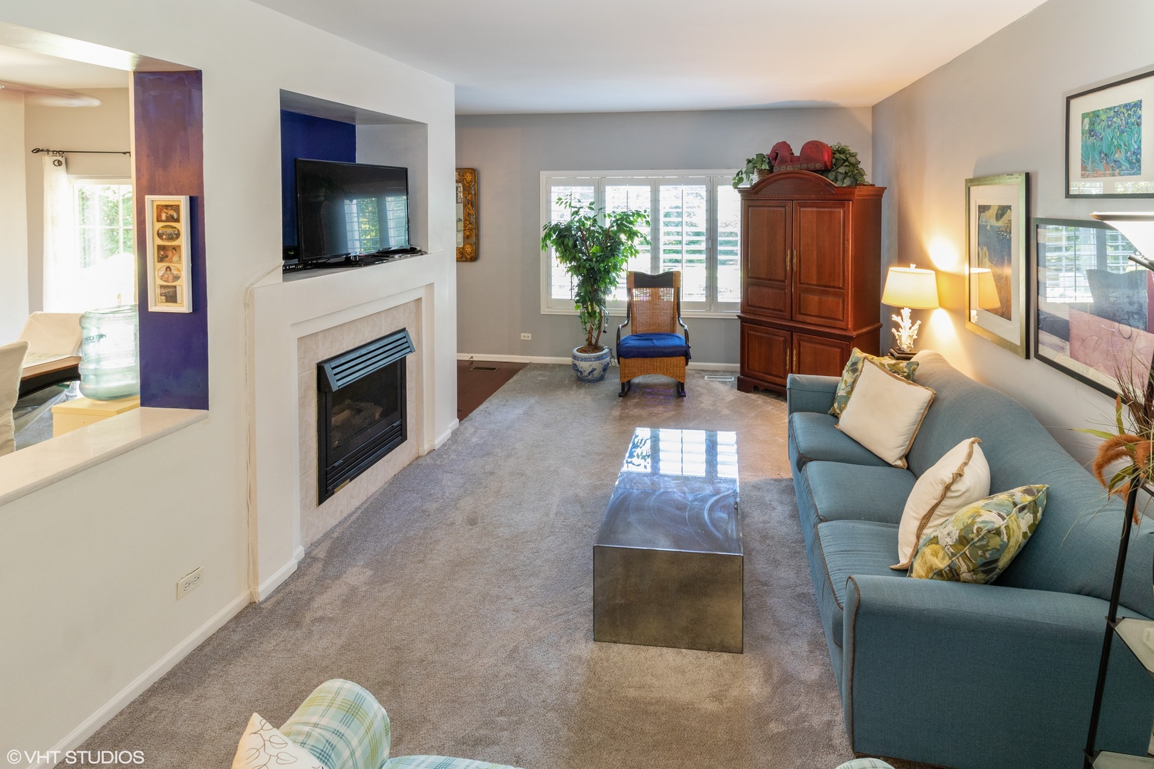 53 Braxton Lane, Unit 53 Aurora, IL 60504 - Photo 4 of 17 a living room with furniture a flat screen tv and a fireplace