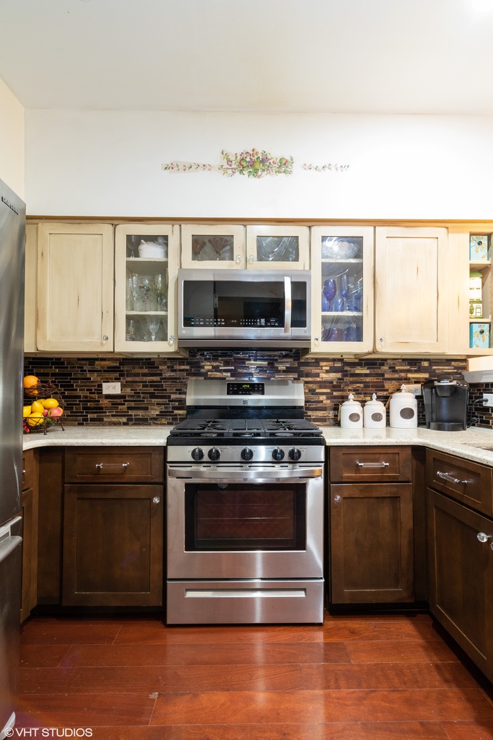 53 Braxton Lane, Unit 53 Aurora, IL 60504 - Photo 7 of 17 a kitchen with stainless steel appliances granite countertop a stove and a sink