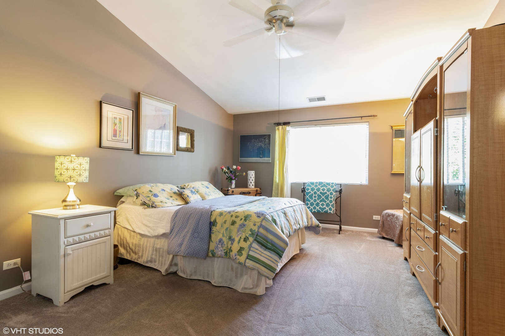 53 Braxton Lane, Unit 53 Aurora, IL 60504 - Photo 9 of 17 a bedroom with a bed and a chandelier