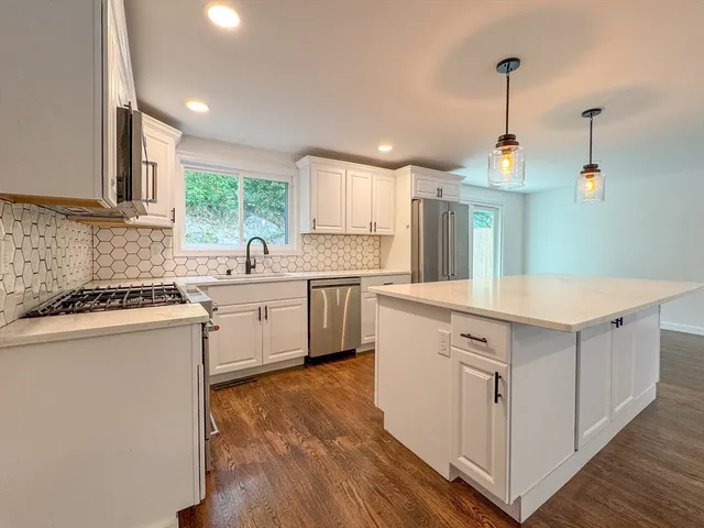 a kitchen with a sink window and cabinets