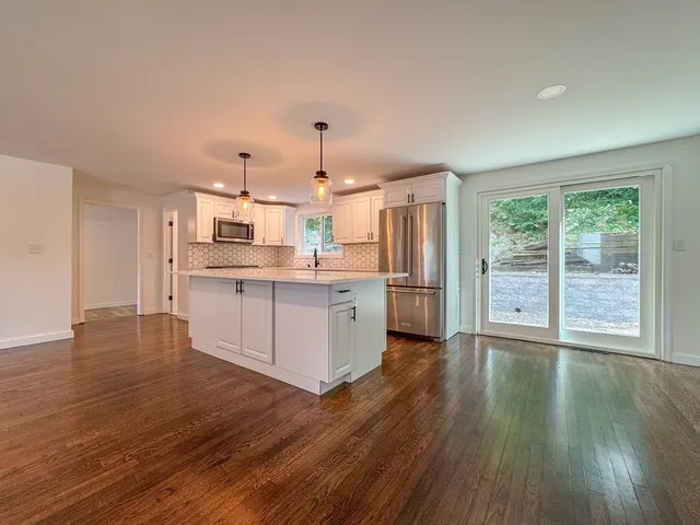 a kitchen with stainless steel appliances a stove top oven and cabinets