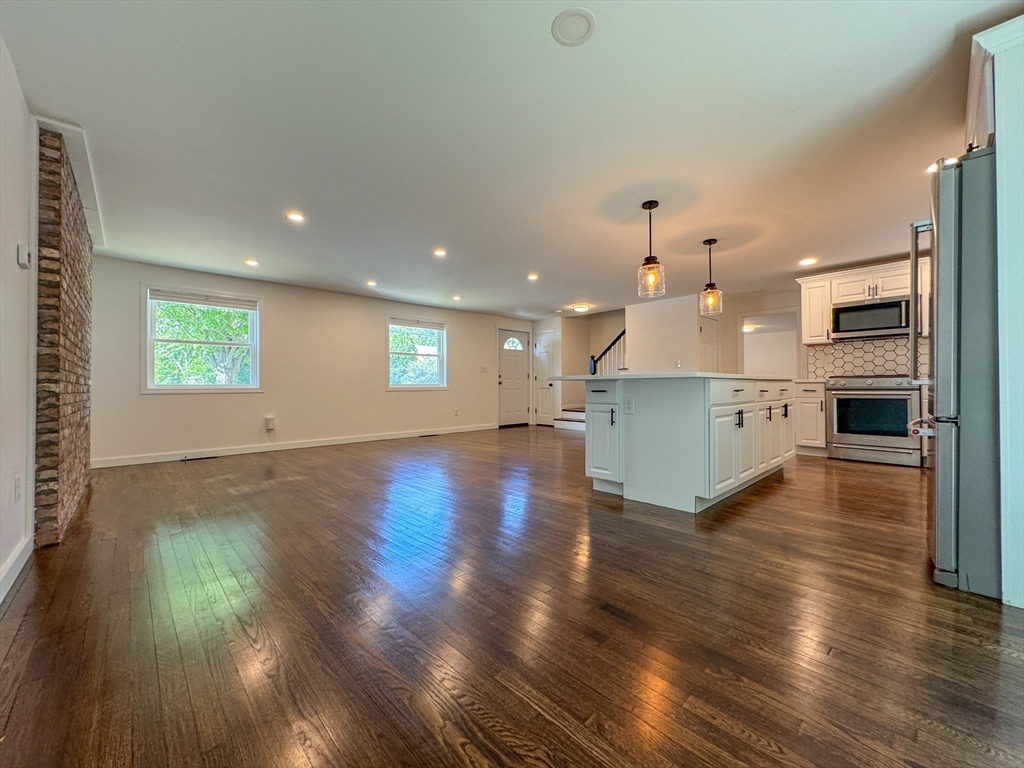 282 Pleasant Street Marblehead, MA 01945 - Photo 13 of 28 a view of a kitchen with a sink stove cabinets and empty room