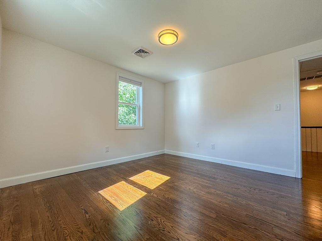 282 Pleasant Street Marblehead, MA 01945 - Photo 16 of 28 an empty room with wooden floor and windows