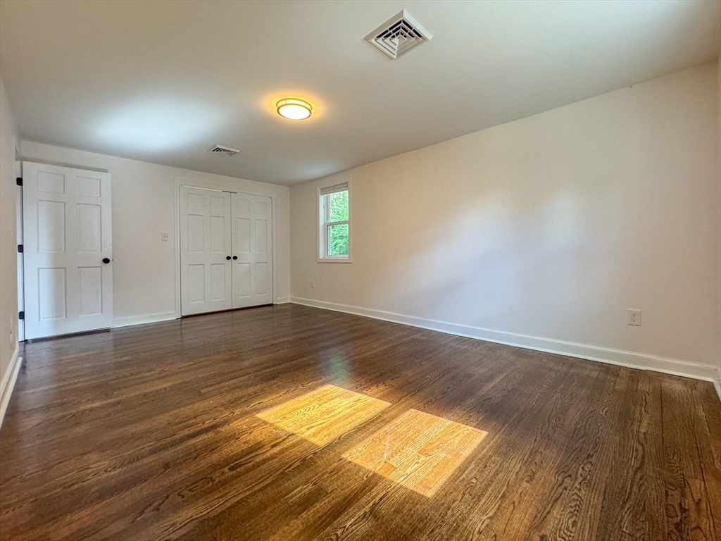 282 Pleasant Street Marblehead, MA 01945 - Photo 19 of 28 an empty room with wooden floor and windows
