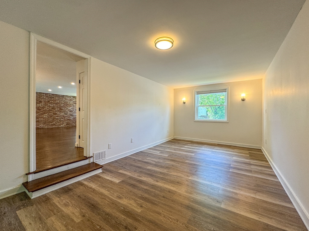 282 Pleasant Street Marblehead, MA 01945 - Photo 24 of 28 an empty room with wooden floor and windows