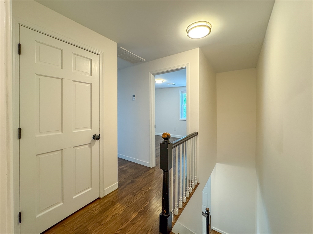 282 Pleasant Street Marblehead, MA 01945 - Photo 8 of 28 a view of a hallway with wooden floor and staircase