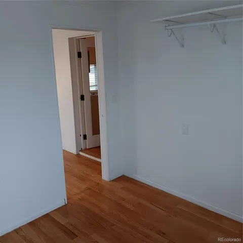 a view of a room with wooden floor and window