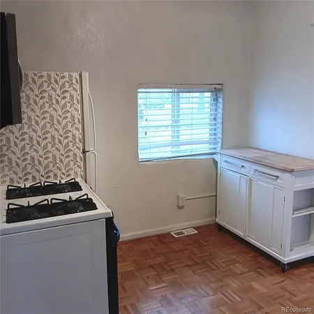 a kitchen with stainless steel appliances granite countertop a stove and a microwave
