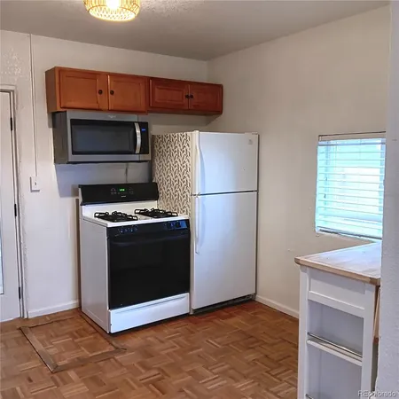 a view of a kitchen with wooden floor