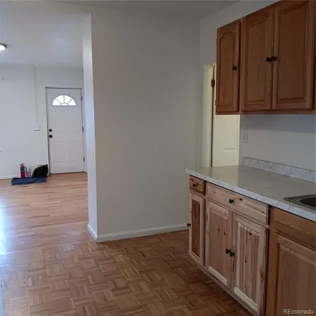 a kitchen with a refrigerator and a stove