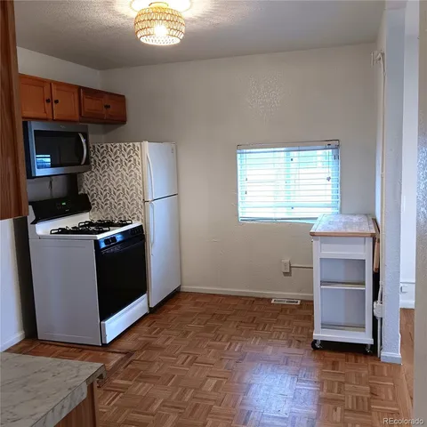 a view of a room with wooden floor and windows