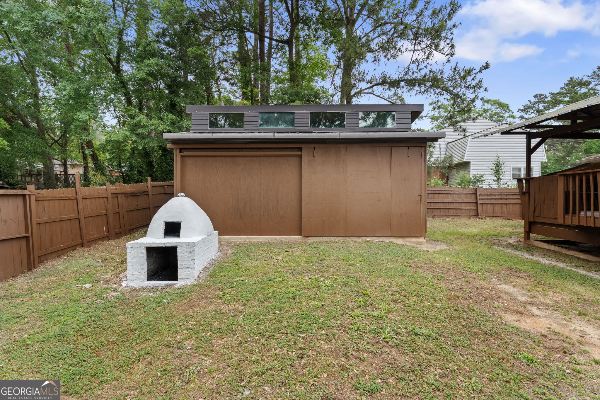 6463 Maddox Road Morrow, GA 30260 - Photo 37 of 46 a view of a tiny house with a yard and large tree