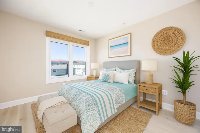 a bedroom with a large bed and a potted plant