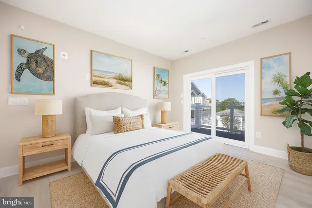 a bedroom with a bed and a painting on the wall