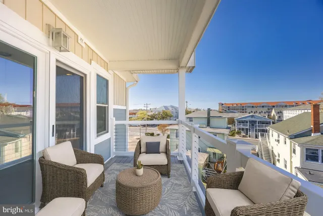 a living room with furniture a fireplace and a floor to ceiling window