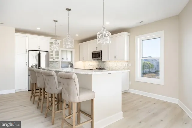 a large kitchen with a table and chairs