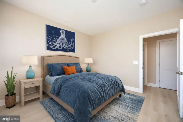 a bedroom with bed and a potted plant