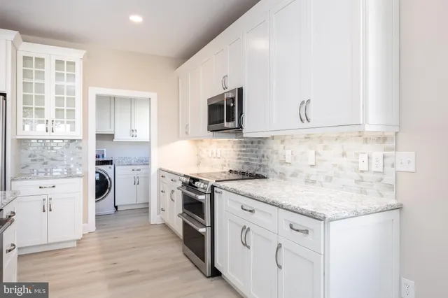 a kitchen with stainless steel appliances granite countertop a stove and a sink
