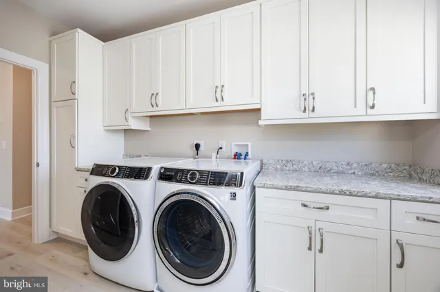 a kitchen with white cabinets and a sink