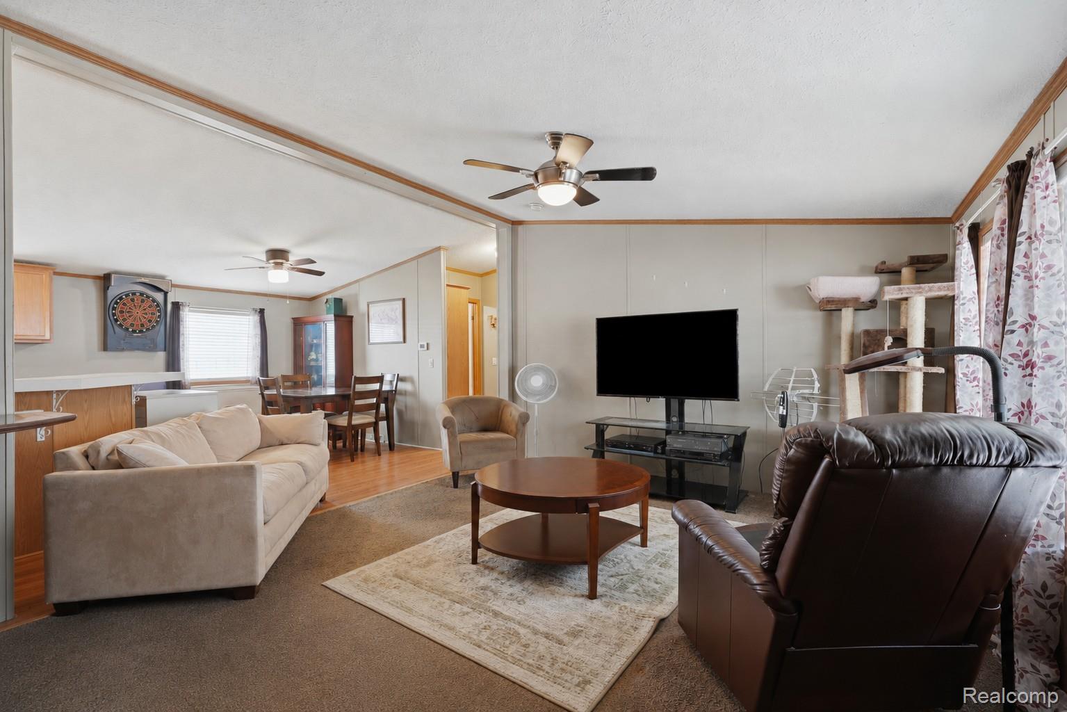 Open concept living and dining areas, recessed lighting, and ceiling fans