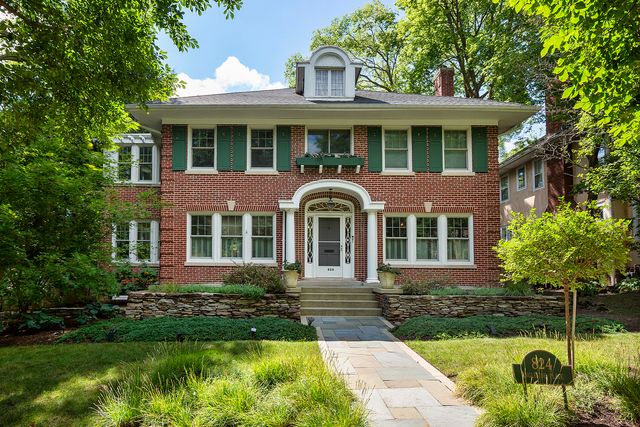 a front view of a house with a yard and porch