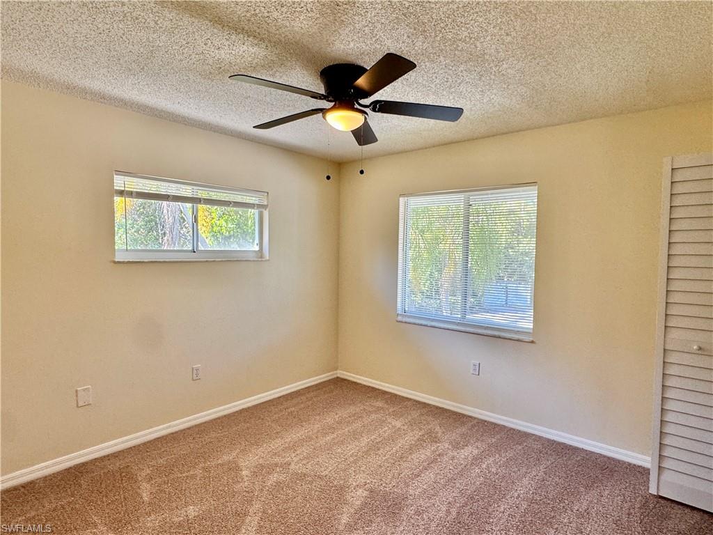 5665 Whitaker Road, Unit A201 Naples, FL 34112 - Photo 19 of 30 a view of an empty room with a window