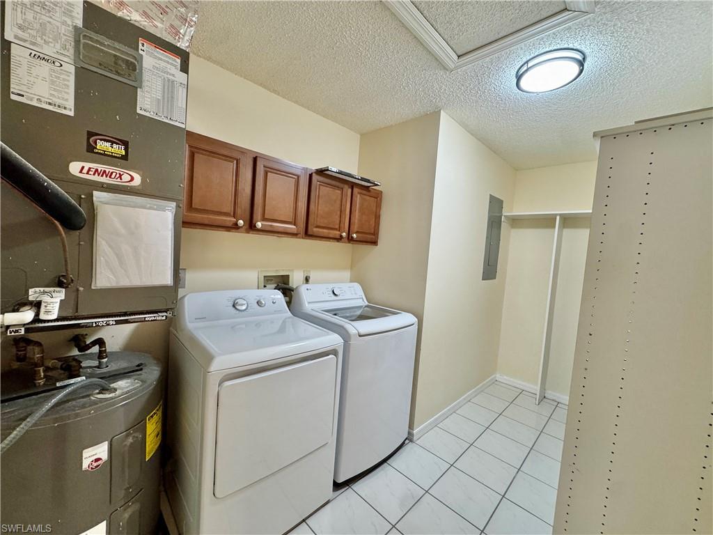 5665 Whitaker Road, Unit A201 Naples, FL 34112 - Photo 22 of 30 a utility room with dryer and washer