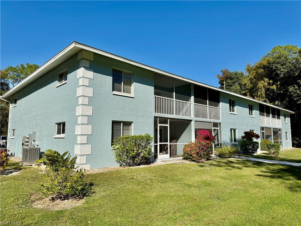 5665 Whitaker Road, Unit A201 Naples, FL 34112 - Photo 24 of 30 a front view of house with yard