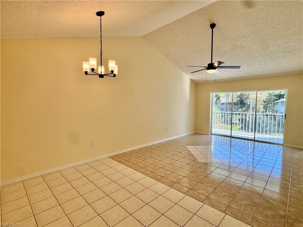 5665 Whitaker Road, Unit A201 Naples, FL 34112 - Photo 5 of 30 a view of empty room with wooden floor and fan