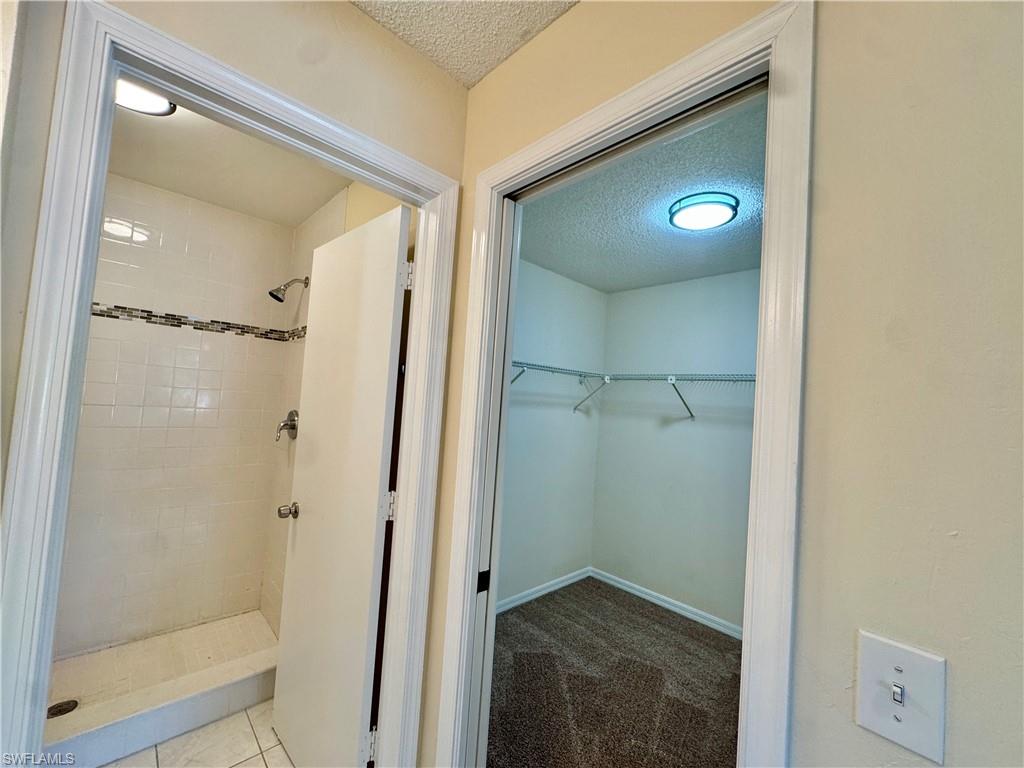 5665 Whitaker Road, Unit A201 Naples, FL 34112 - Photo 8 of 30 a bathroom with a shower and a sink