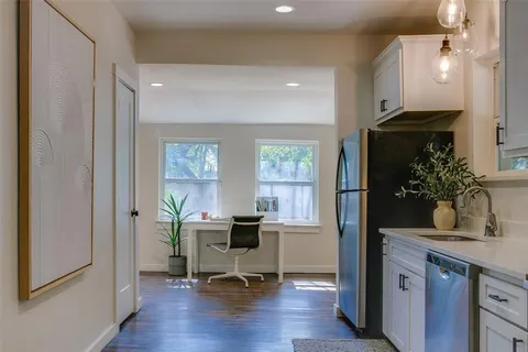 a view of a workspace with furniture and a window