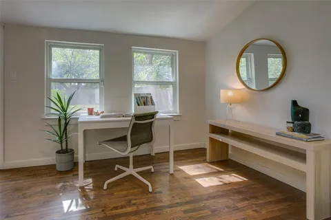 a work room with furniture and a potted plant