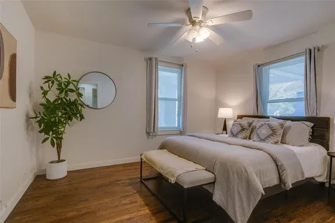a bedroom with bed and a potted plant