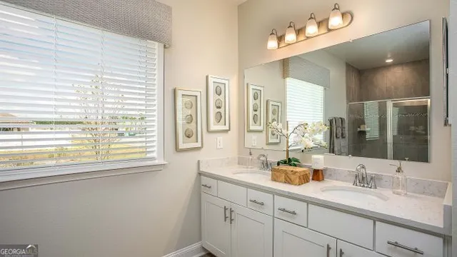 a bathroom with a sink double vanity and a mirror