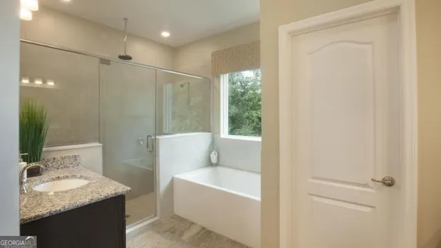 a bathroom with a granite countertop sink mirror and a bathtub