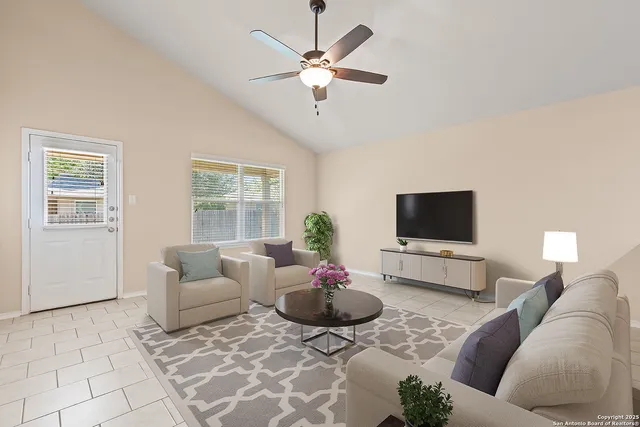 a view of an empty room with a ceiling fan
