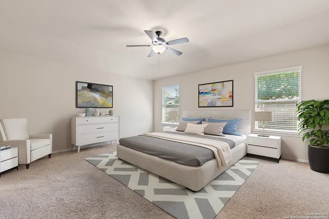 an empty room with chandelier fan and windows
