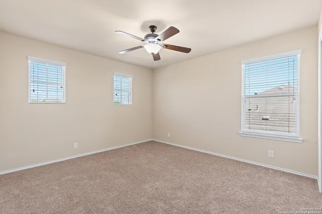 an empty room with ceiling fan