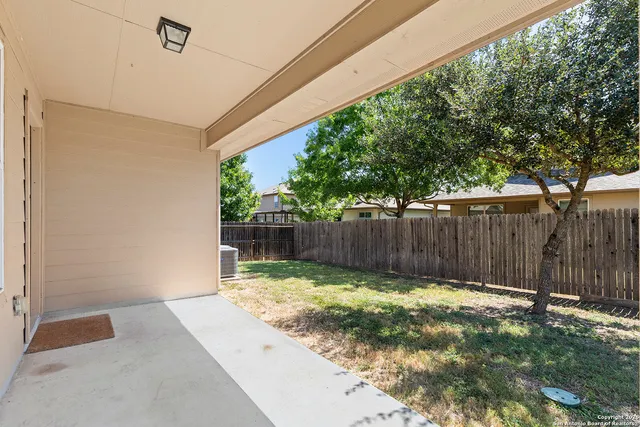 a view of a backyard with wooden fence