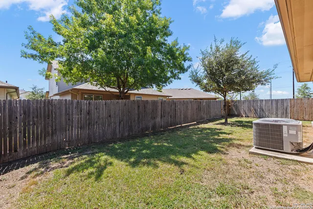 a view of backyard with a table and chairs