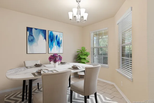a view of a chandelier fan and entryway