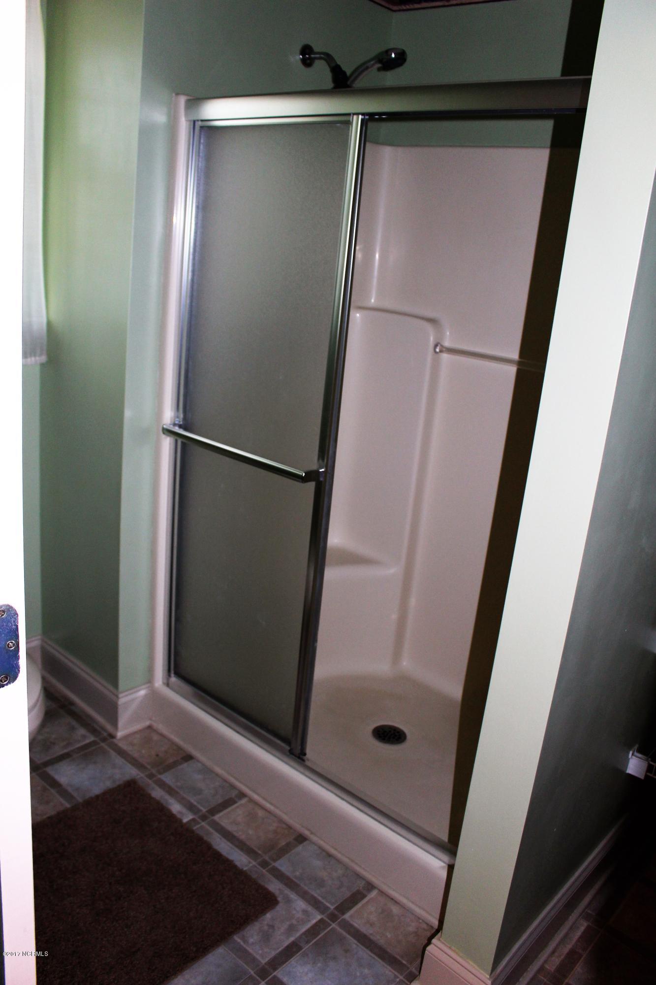451 Becton Road Havelock, NC 28532 - Photo 59 of 87 Walk in shower in ground level bedroom with sink and toilet