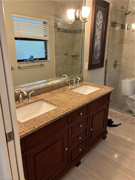 175 5th Street South Naples, FL 34102 - Photo 7 of 8 a bathroom with a granite countertop sink and a mirror