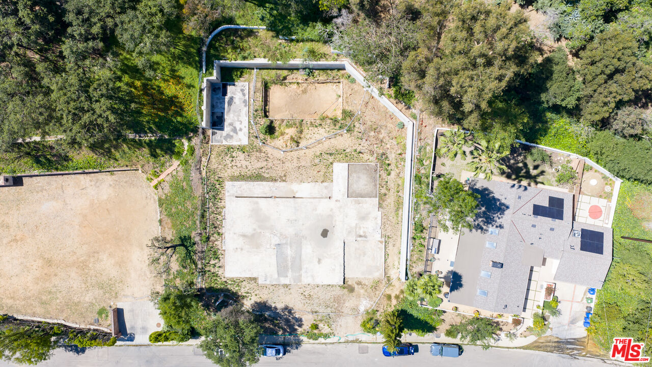 1303 Marinette Road Pacific Palisades, CA 90272 - Photo 2 of 11 an aerial view of a house with a yard and large trees
