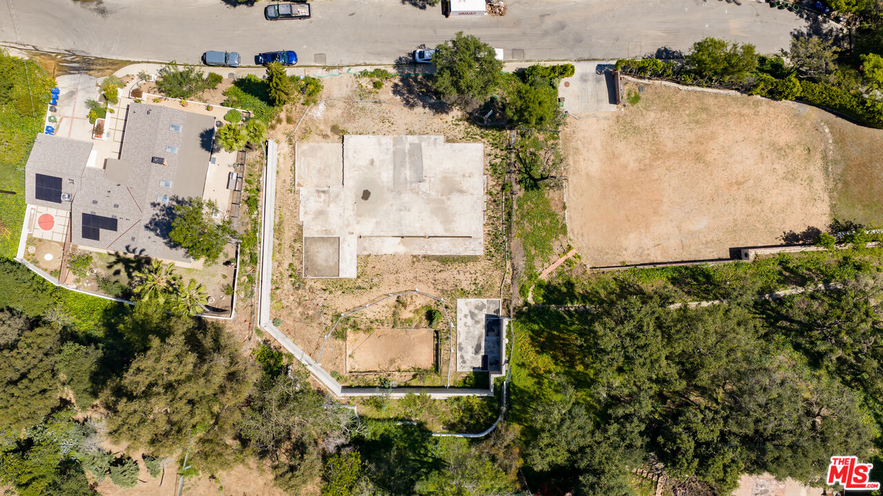 1303 Marinette Road Pacific Palisades, CA 90272 - Photo 6 of 11 an aerial view of a house with a yard