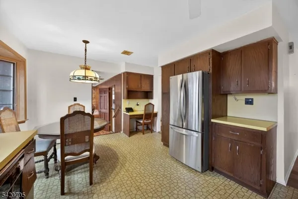 a dining room with furniture a chandelier and window