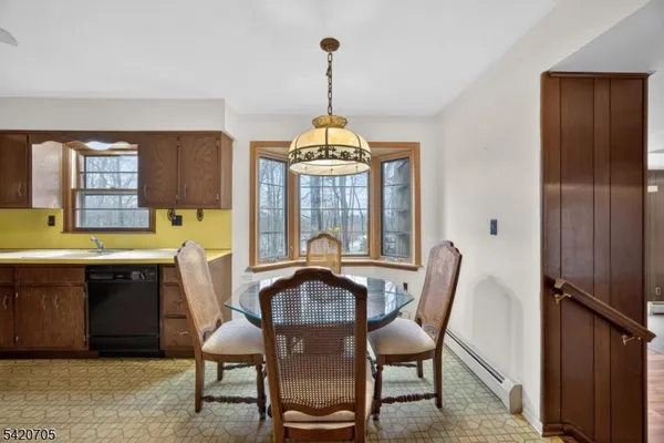 a view of a dining room with furniture and window